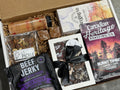 Gift box with beef jerky, coffee, and other snacks on a gray surface