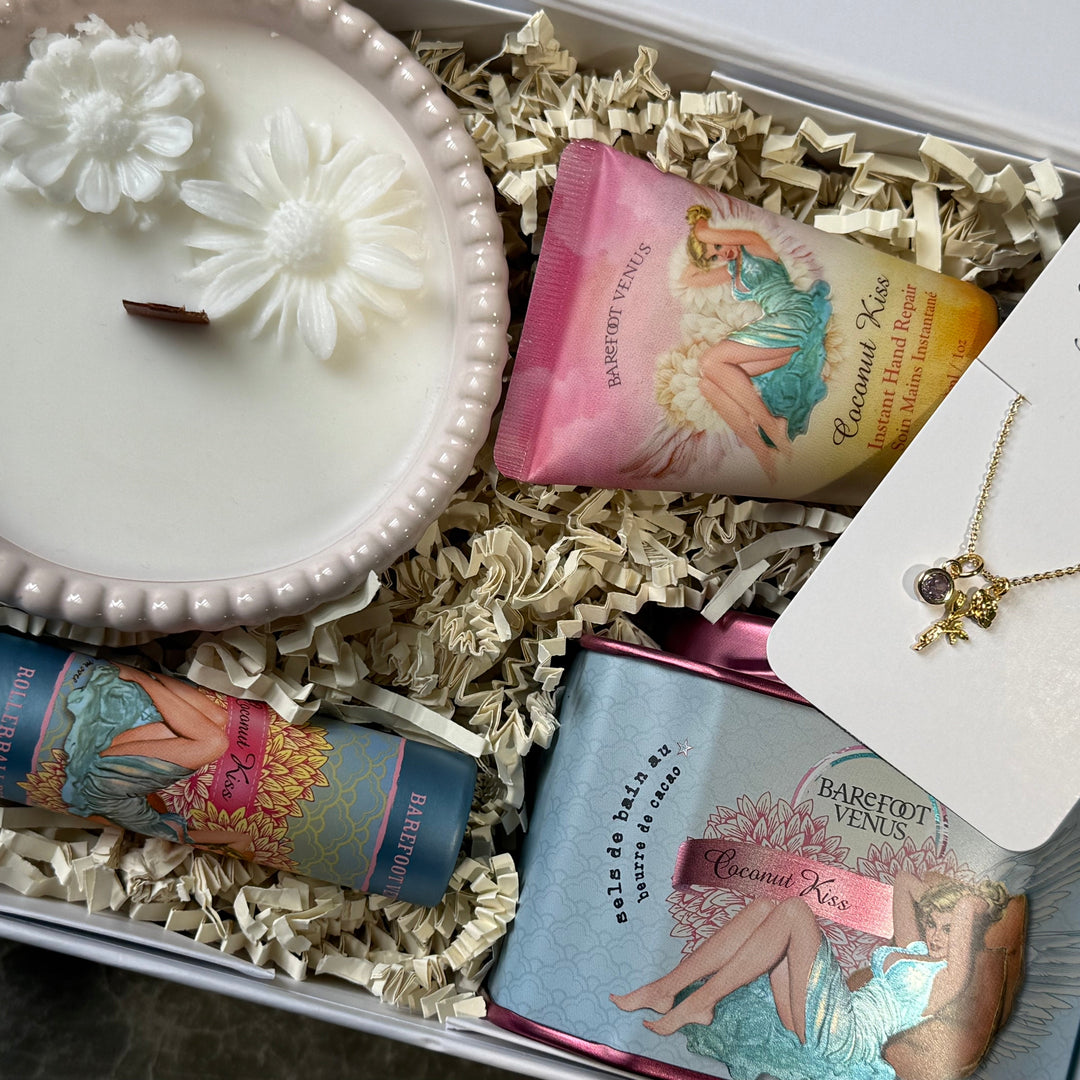 Gift set with candle, lip balm, and necklace in a decorative box.