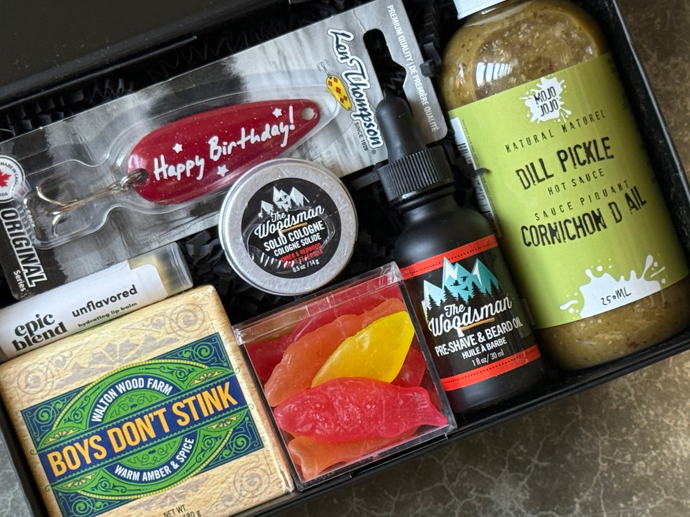 Collection of men's grooming products including a bottle, jar, and soap in a box.