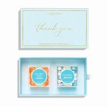 A light blue gift box with a matching lid labeled &