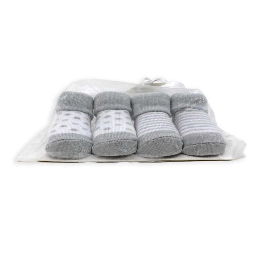 Set of gray socks with white patterns in a clear plastic bag on a white background