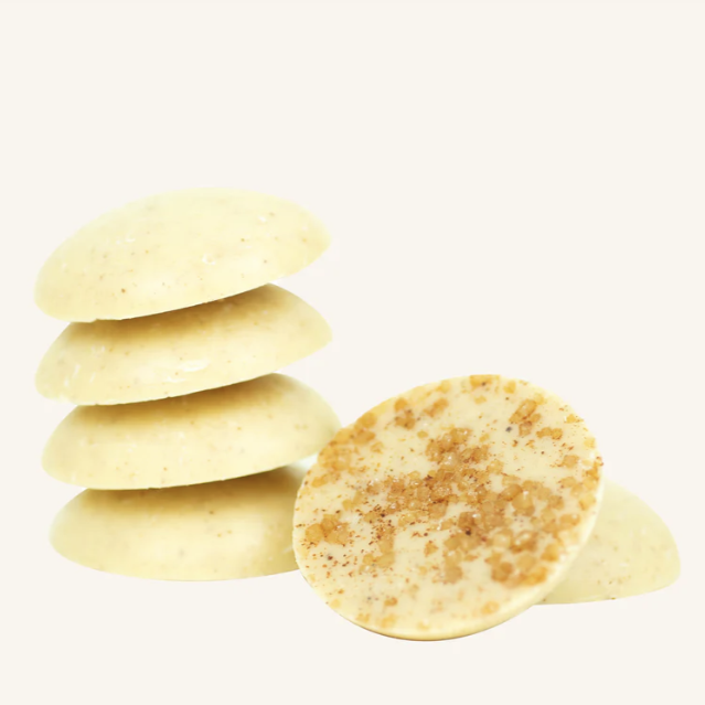 Stack of round, beige-colored cookies on a white background
