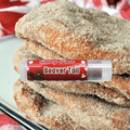 Saucy Face Beaver Tail Lip Balm tube with colorful packaging and product label, designed to moisturize and protect lips.