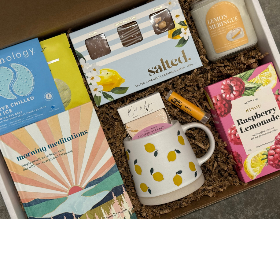 Gift box with a mug, books, and snacks on a white background