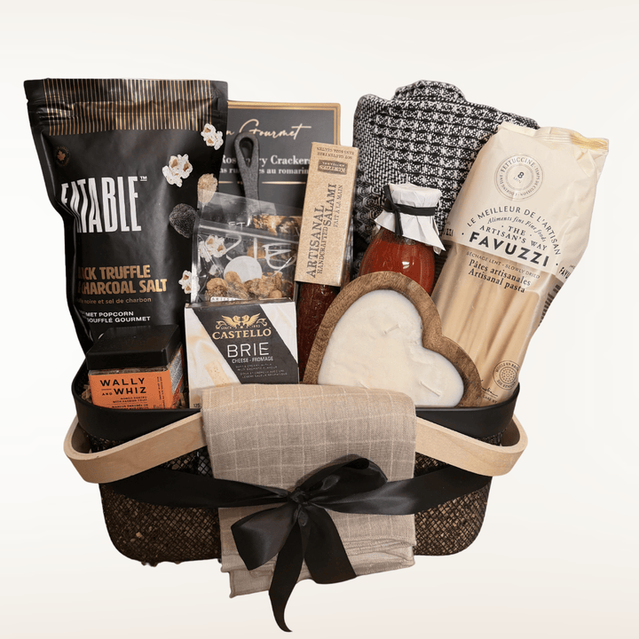 Gift basket with assorted items including a bottle of wine, cheese, and crackers on a white background.