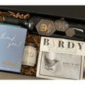 Gift Smack Gift Company wine, coffee, and thanks gift box featuring a selection of wine bottles, coffee, and thank-you notes.
