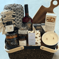 Cozy Night In gift basket by Gift Smack with wine, featuring snacks, candles, and relaxing items for a comforting evening.