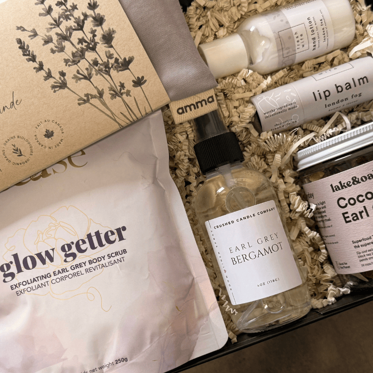 Assorted beauty products including a bottle, tube, and pouches in a box with visible branding.