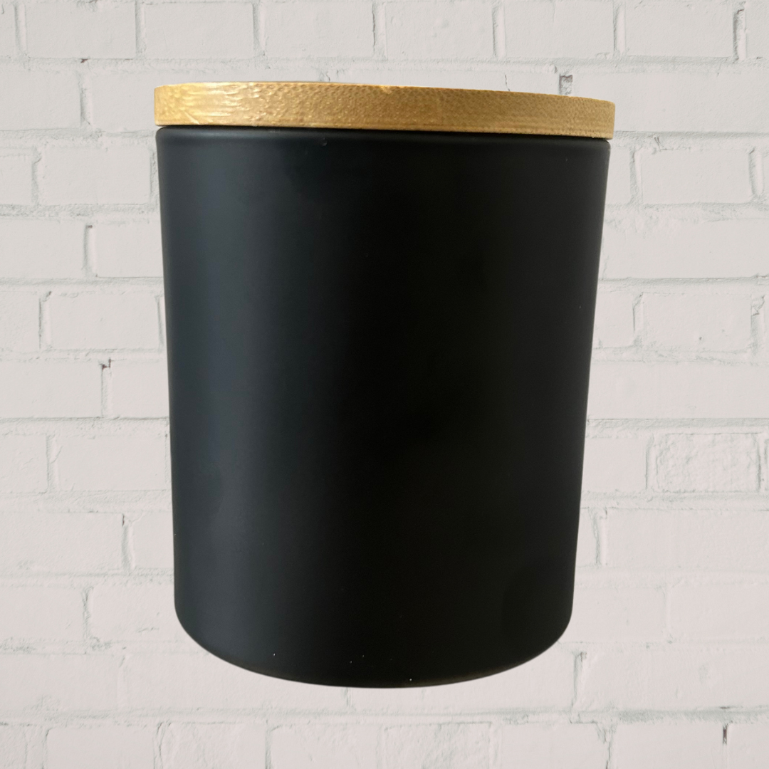 Black  jar with a gold lid on a white brick wall background
