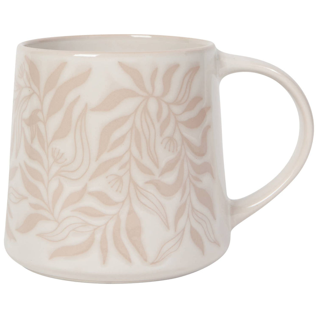 White mug with beige leaf pattern on a white background