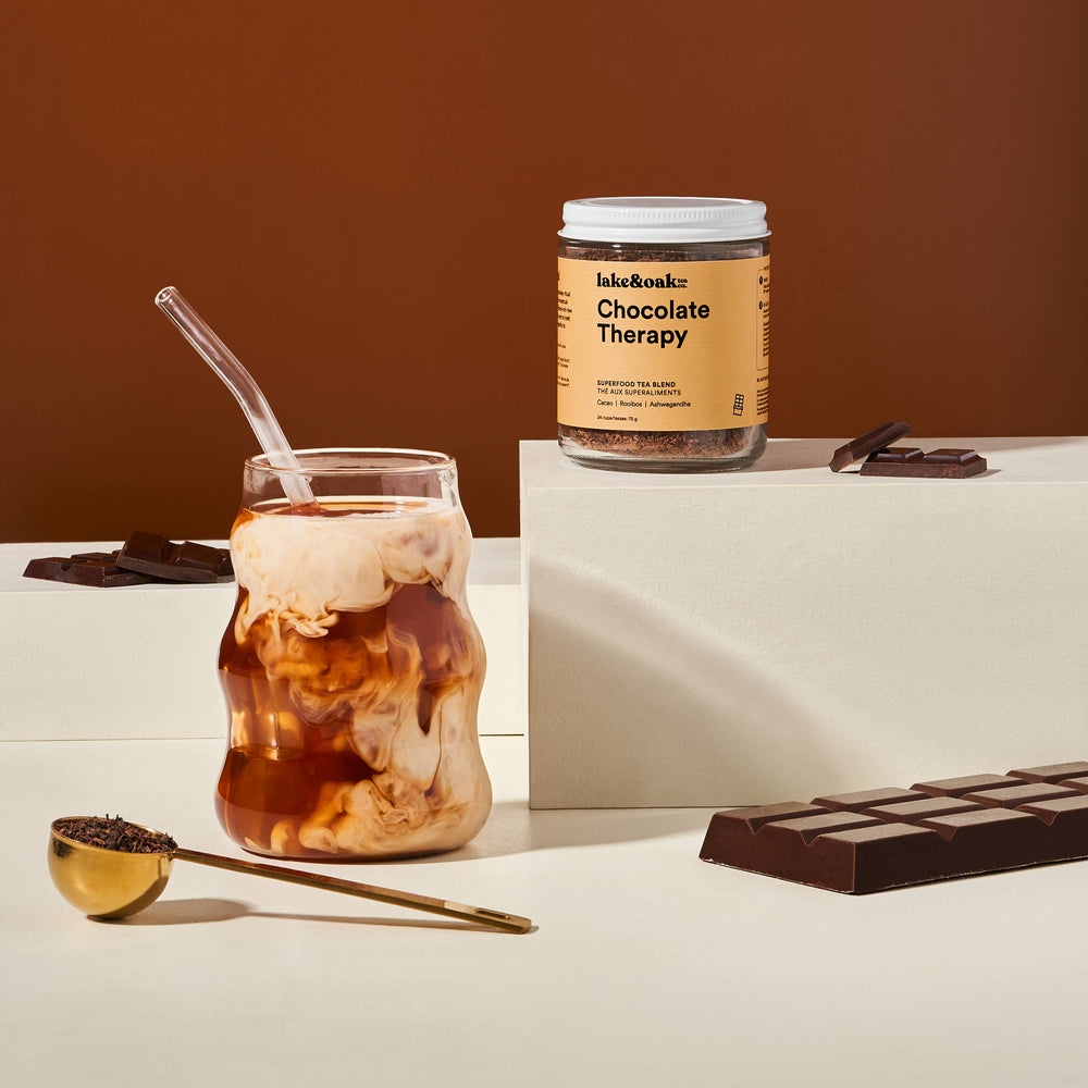 Iced coffee with a jar labeled 'Chocolate Therapy' on a brown background