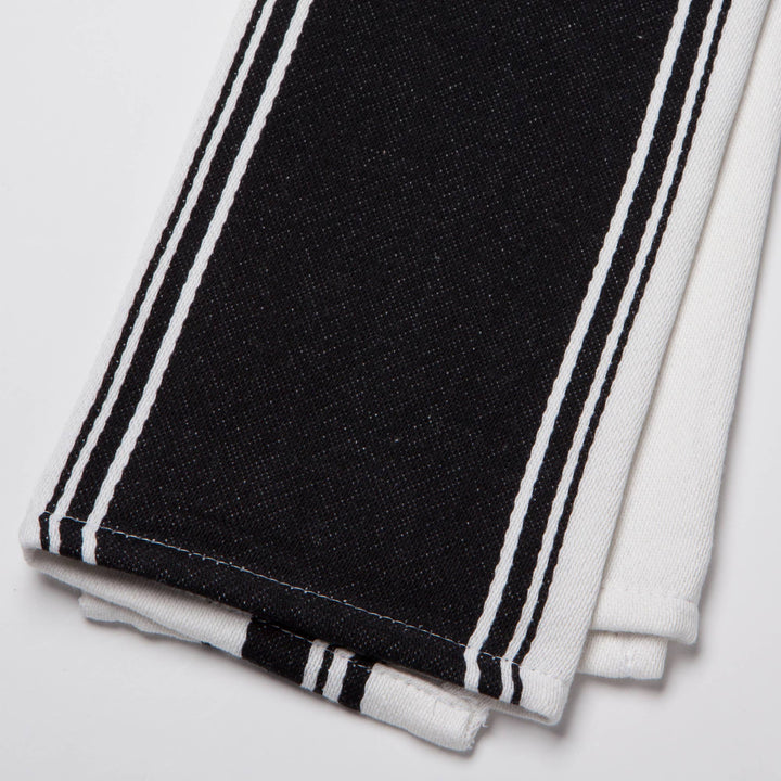 Black and white striped fabric on a light gray background