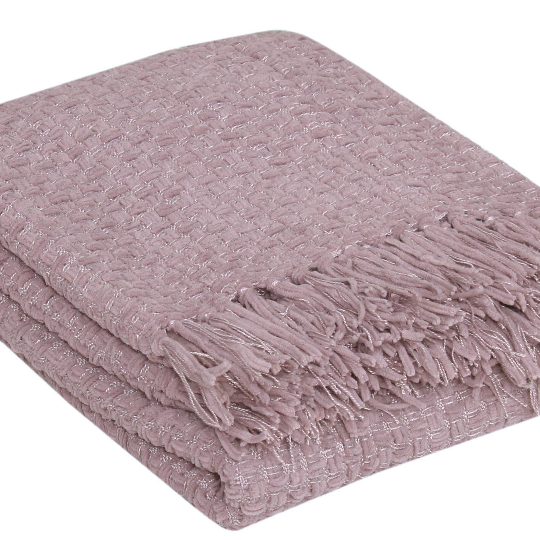A folded dusty pink woven throw blanket with fringed edges, shown on a plain white background.