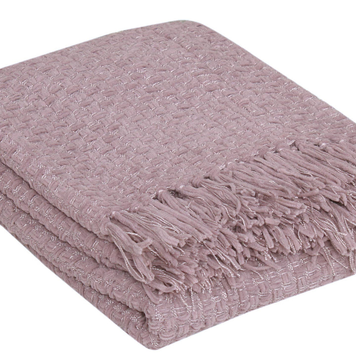 A folded dusty pink woven throw blanket with fringed edges, shown on a plain white background.