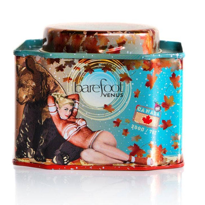 Barefoot Venus candle tin with bear and woman design on a white background