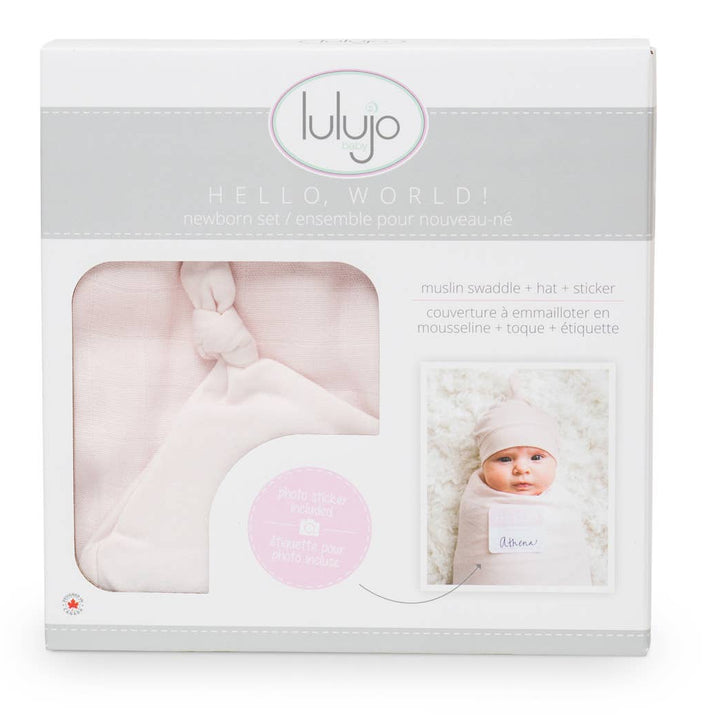 Lulujo baby gift set packaging with pink swaddle, hat, and sticker on a white background