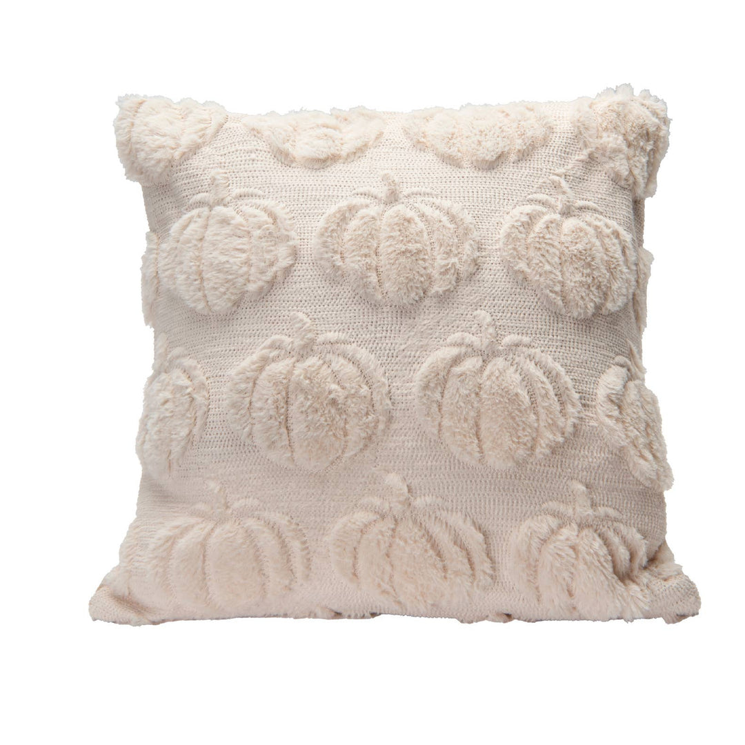 A square throw pillow in a warm cream or off-white color, featuring a textured knit fabric with raised, fluffy pumpkin motifs and a ruffled trim along the top edge, shown against a plain white background.
