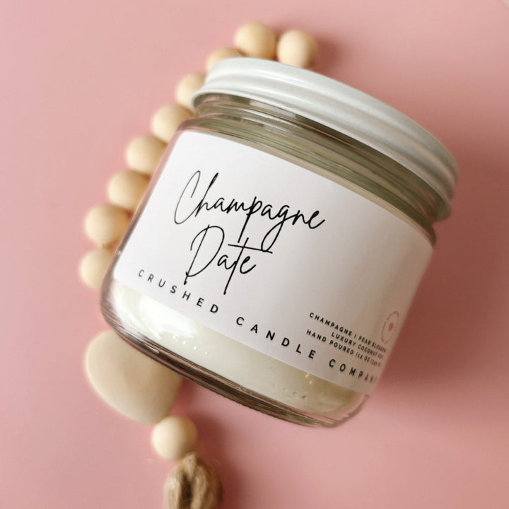 Jar of 'Champagne Date' crushed candle on a pink background