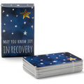 IN RECOVERY sober living intention card deck by May You Know Joy Inc., with colorful affirmation cards on a wooden surface.