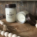 Black Raspberry & Vanilla soy wax candle by North Country Candle, 12 oz with a lit wick, showcasing a cozy, inviting ambiance.