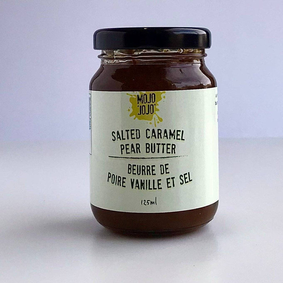 Jar of salted caramel pear butter on a white background