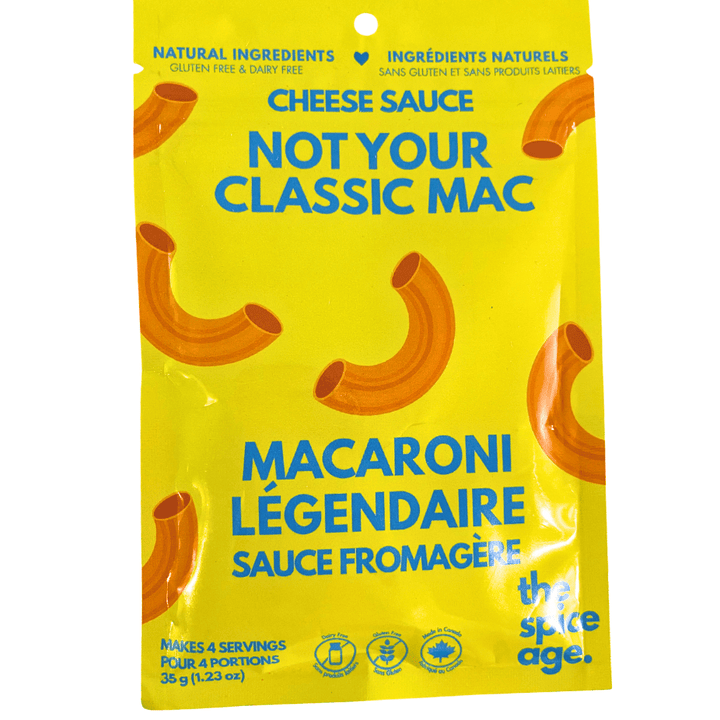 A jar of The Spice Age Mac &amp; Cheese Sauce in pantry, creamy cheese sauce for pasta, with label showing product details.
