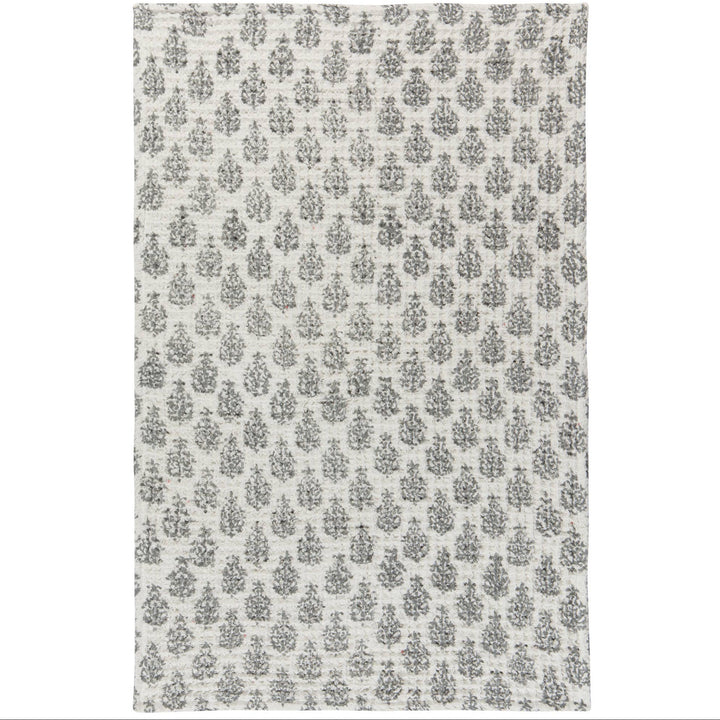 A rectangular area rug with a distressed, vintage-style repeating floral or damask pattern in dark gray on an off-white background.