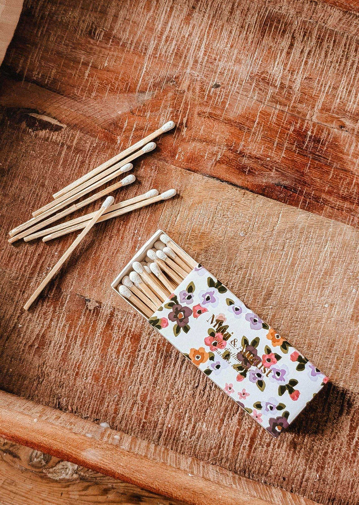 Matches with floral patterned box on a wooden surface