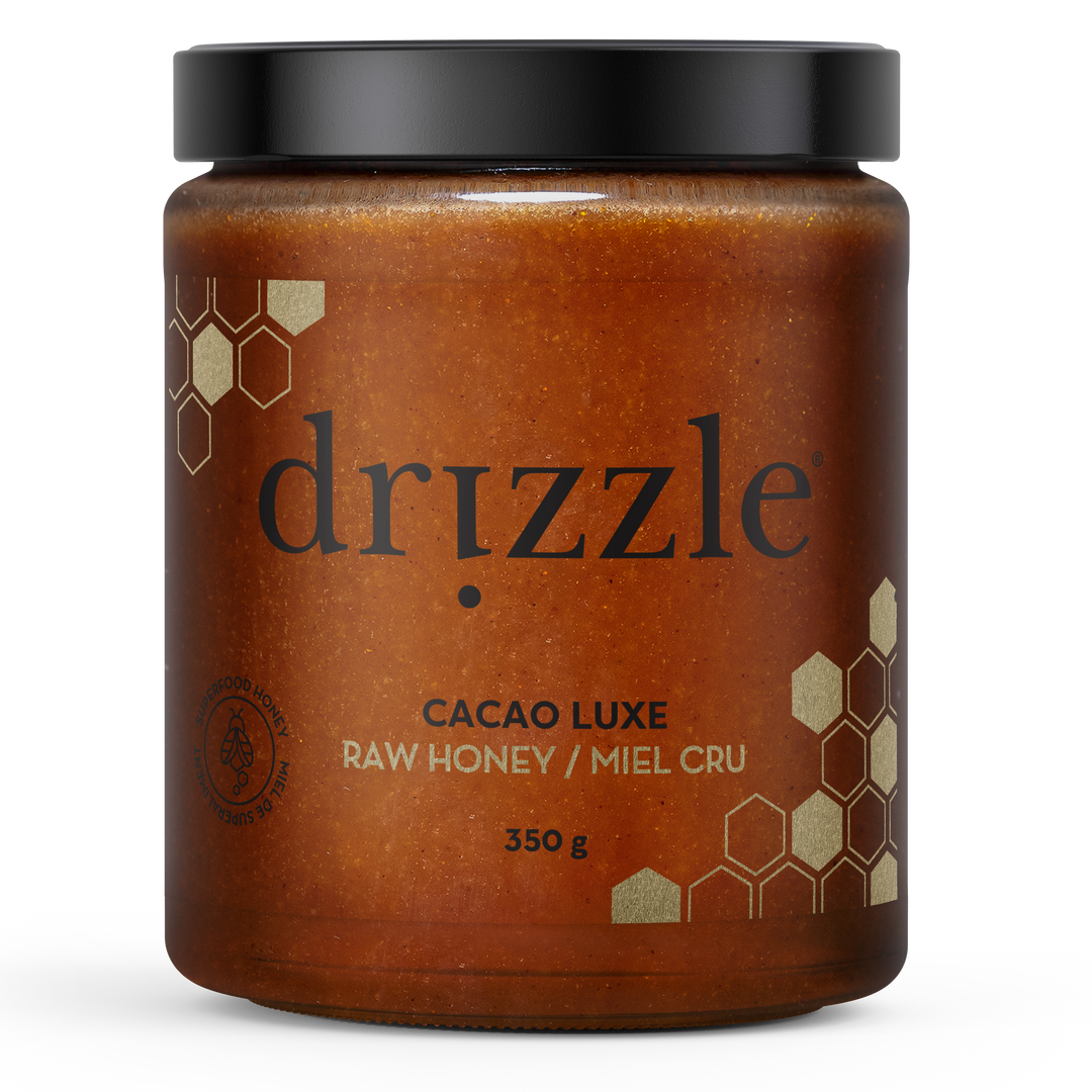 Jar of drizzle Cacao Luxe raw honey on a white background