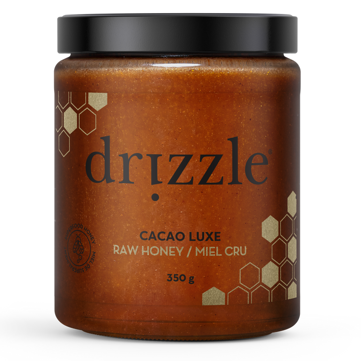 Jar of drizzle Cacao Luxe raw honey on a white background
