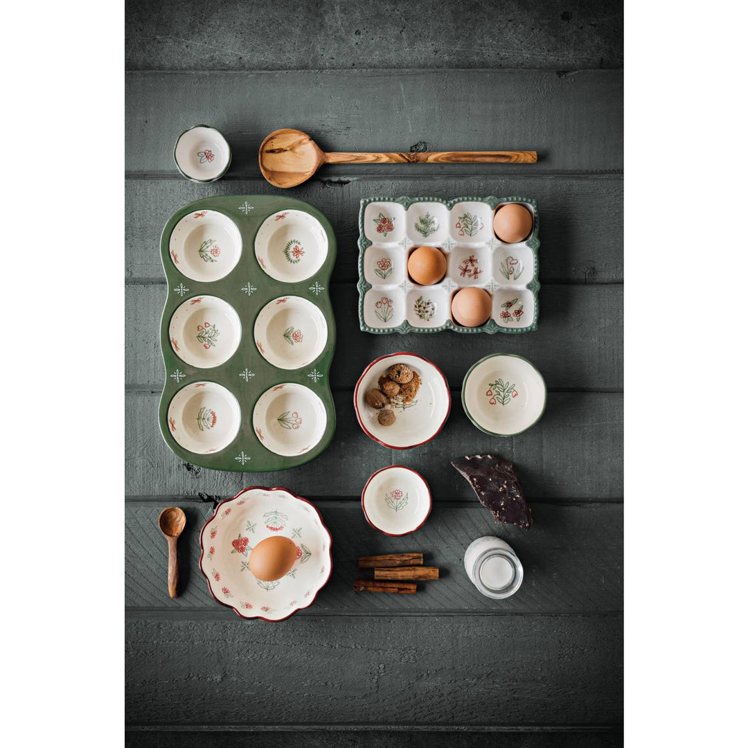 Collection of ceramic dishes and kitchen items on a dark wooden surface