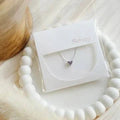 Reversible birthstone heart necklace by Sweet Three Designs showcasing three different designs in a jewelry image.