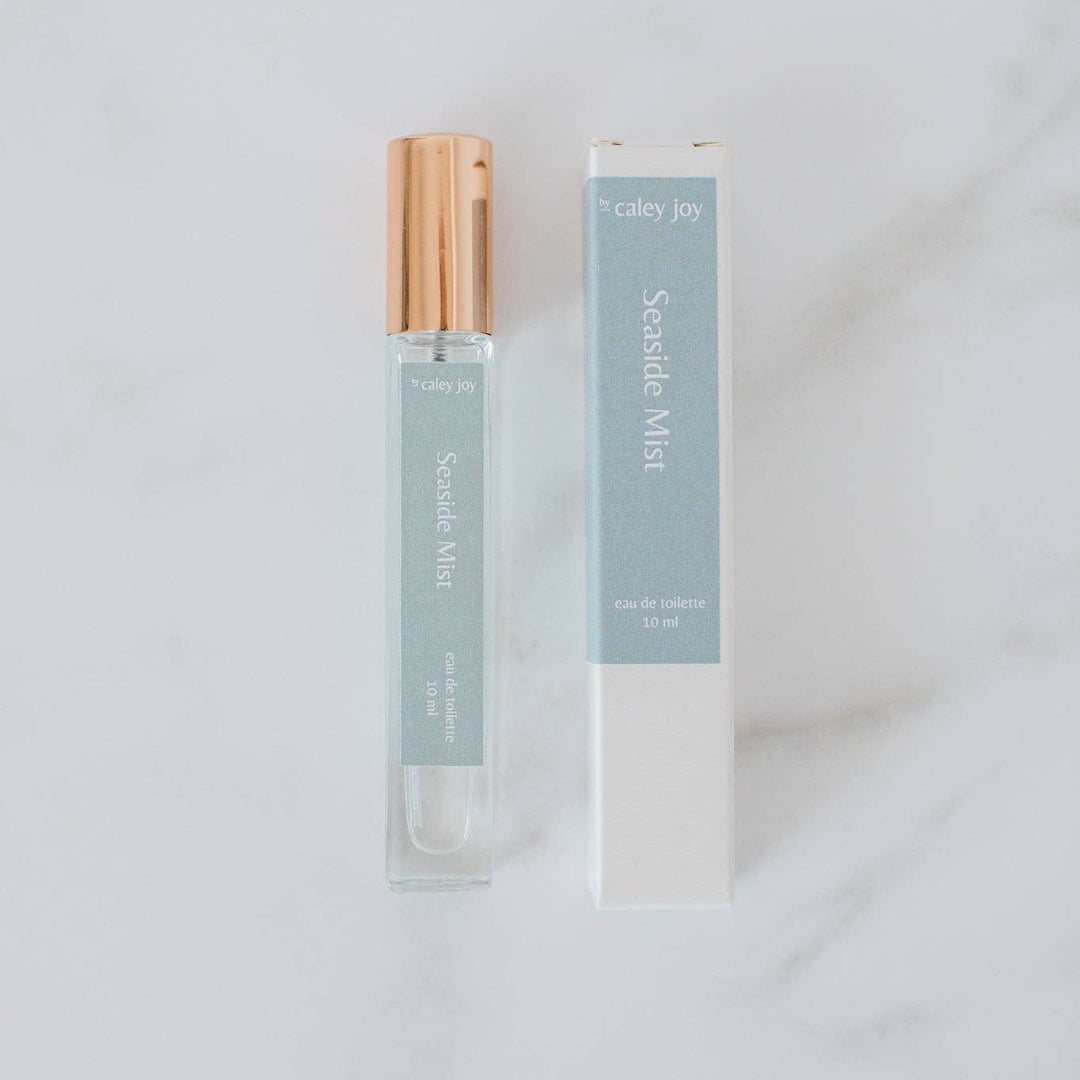 Perfume bottle and packaging on a light gray background