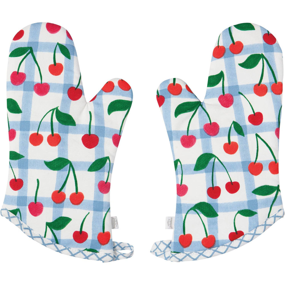 Pair of oven mitts with cherry pattern on a white background