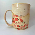 Ceramic mug with strawberry pattern on a white background