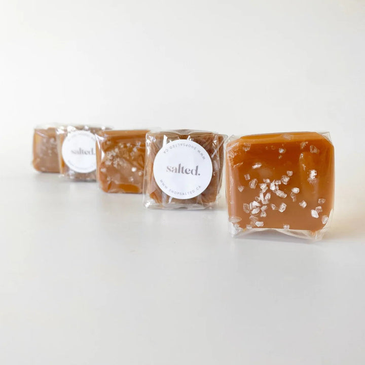 Three packages of salted caramel on a white background