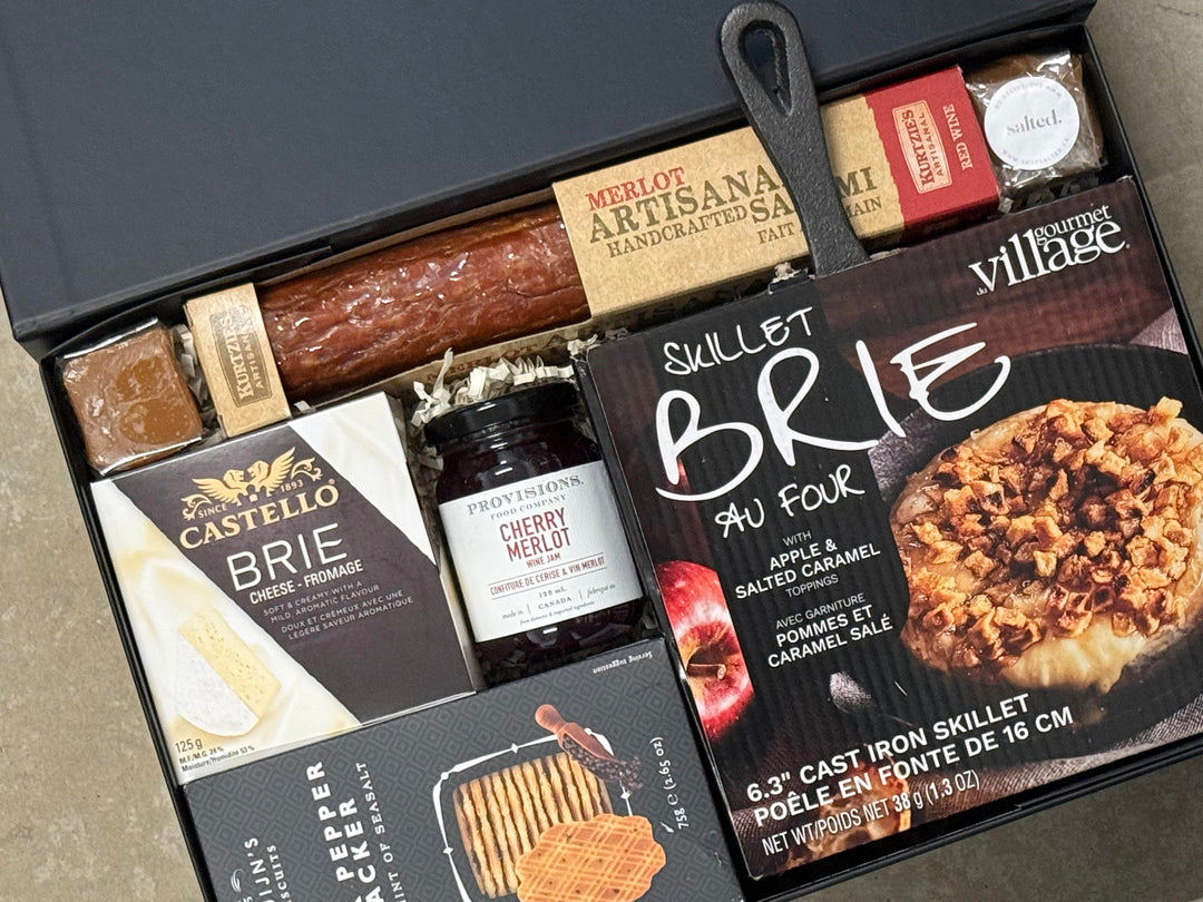 Gourmet food gift set with various items including a skillet brie and Castello brie.
