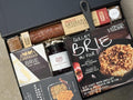 Gourmet food gift set with various items including a skillet brie and Castello brie.