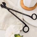 Matte black wick trimmer for candles by Mimi & August, featuring a sleek design and precise trimming tool.